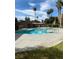 Community pool with surrounding patio and palm trees at 1826 N Decatur Blvd # 101, Las Vegas, NV 89108