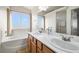 Bathroom features double sinks, soaking tub, and wood cabinets at 1900 E Highland Ave, Pahrump, NV 89048