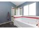Bathroom with soaking tub, shower, and a window for natural light at 207 Charter Oak St, Henderson, NV 89074