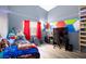 Bright bedroom with a gaming setup and colorful wall art at 207 Charter Oak St, Henderson, NV 89074