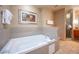 Relaxing bathroom with a large soaking tub and granite accents at 211 E Flamingo Rd # 414, Las Vegas, NV 89169
