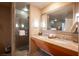 Elegant bathroom with double sinks, granite countertops, and a glass shower at 211 E Flamingo Rd # 414, Las Vegas, NV 89169