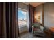Bedroom with sitting chair and view, showcasing modern decor at 211 E Flamingo Rd # 414, Las Vegas, NV 89169