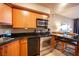 Modern condo kitchen, wood cabinets, granite counters at 211 E Flamingo Rd # 414, Las Vegas, NV 89169
