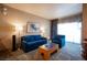 Spacious living room with blue sofas, coffee table, and large window at 211 E Flamingo Rd # 414, Las Vegas, NV 89169