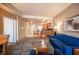 Open concept kitchen and living room with a breakfast bar and blue couches at 211 E Flamingo Rd # 414, Las Vegas, NV 89169