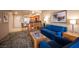 Open concept living area with kitchen, breakfast bar, and blue sofas at 211 E Flamingo Rd # 414, Las Vegas, NV 89169