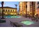 Evening view of the community pool and spa area with comfortable seating at 2405 W Serene Ave # 729, Las Vegas, NV 89123