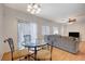 Dining area with glass top table and chairs near living room at 2495 April Breeze Ln, Henderson, NV 89002