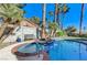 Relaxing kidney-shaped pool with spa and brick coping, nestled in a desert landscape at 2572 Hidden Forest Cir, Henderson, NV 89074