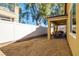 Landscaped backyard with covered patio and a white fence at 2804 Colts Ave, North Las Vegas, NV 89032