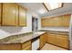 Kitchen with light wood cabinets and a double sink at 3125 N Buffalo Dr # 2136, Las Vegas, NV 89128
