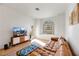 Bright living room with a leather sectional sofa and large TV at 3125 N Buffalo Dr # 2136, Las Vegas, NV 89128
