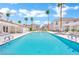Inviting community pool with palm trees and surrounding patio at 3125 N Buffalo Dr # 2136, Las Vegas, NV 89128