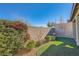 Landscaped backyard with artificial turf, plants, and a block wall at 393 Mullen Ave, Henderson, NV 89044