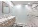 Modern bathroom with a large walk-in shower, floating vanity, and hexagon tile floor at 4025 Ridgewood Ave, Las Vegas, NV 89120