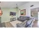 Spacious living room with gray sectional sofa and large mirror at 4025 Ridgewood Ave, Las Vegas, NV 89120