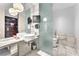 Elegant bathroom with double sinks, frosted glass partition, and toilet at 4381 W Flamingo Rd # 3819, Las Vegas, NV 89103