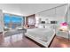 Bright bedroom featuring a king bed, city views, and hardwood floors at 4381 W Flamingo Rd # 3819, Las Vegas, NV 89103
