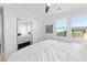 Inviting bedroom featuring a large mirror, white bedding, and natural light at 483 Astillero St, Las Vegas, NV 89138