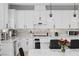 Modern kitchen with white cabinets, quartz countertops, and a mosaic backsplash at 483 Astillero St, Las Vegas, NV 89138