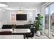 Bright living room featuring a large TV, modern cabinet, and sliding glass doors at 483 Astillero St, Las Vegas, NV 89138