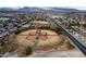 Aerial view of a baseball field complex within a residential neighborhood, set against a backdrop of mountains at 6701 Dorita Ave # 201, Las Vegas, NV 89108