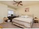 Comfortable bedroom with a ceiling fan, ample natural light, and an adjacent desk area for work or study at 6701 Dorita Ave # 201, Las Vegas, NV 89108