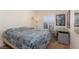 Inviting bedroom featuring a comfortable bed, shuttered window, and a functional desk setup at 6701 Dorita Ave # 201, Las Vegas, NV 89108