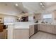 Bright kitchen featuring a peninsula, tiled countertops, stainless steel appliances, and an open view to the living room at 6701 Dorita Ave # 201, Las Vegas, NV 89108