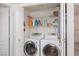Convenient laundry room with a side-by-side washer and dryer, shelving, and ample storage space behind closed doors at 6701 Dorita Ave # 201, Las Vegas, NV 89108