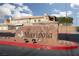 Welcoming community entrance with a prominent 'Mariposa' sign surrounded by lush landscaping at 6701 Dorita Ave # 201, Las Vegas, NV 89108
