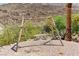Relaxing backyard swing set with stone bench, nestled in desert landscape at 672 Los Feliz St, Las Vegas, NV 89110