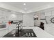 Modern kitchen features white cabinets, breakfast bar and black appliances at 672 Los Feliz St, Las Vegas, NV 89110