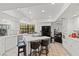 Modern kitchen with white cabinets, large island, and breakfast bar at 672 Los Feliz St, Las Vegas, NV 89110