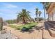Expansive backyard with putting green, palm trees and walkway at 672 Los Feliz St, Las Vegas, NV 89110