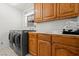 Bright laundry room, washer, dryer, and ample cabinetry at 672 Los Feliz St, Las Vegas, NV 89110