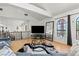 Open living area with hardwood floors, large windows, and a modern entertainment center at 672 Los Feliz St, Las Vegas, NV 89110