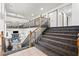 Modern staircase with dark wood railings overlooking game room at 672 Los Feliz St, Las Vegas, NV 89110