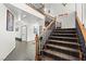 Grand staircase with dark wood railings and plush carpeting at 672 Los Feliz St, Las Vegas, NV 89110