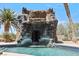 Ornate waterfall grotto feature with gargoyle details at 672 Los Feliz St, Las Vegas, NV 89110