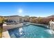 Luxury pool and spa with waterfall feature; resort-style backyard at 6833 Desert Crimson St, Las Vegas, NV 89148