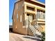 Tan two-story house with stairs leading to the entrance and a paved driveway at 7154 Steele Canyon St, Las Vegas, NV 89118