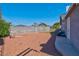 Large backyard with gravel, string lights and small patio at 821 Mar Jay Ct, Las Vegas, NV 89107
