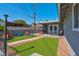 Artificial turf backyard with patio furniture and access to pool at 821 Mar Jay Ct, Las Vegas, NV 89107
