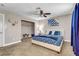 King bedroom with blue and white bedding and ceiling fan at 821 Mar Jay Ct, Las Vegas, NV 89107