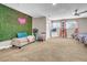 Bedroom with twin beds, seating area, and a green wall at 821 Mar Jay Ct, Las Vegas, NV 89107