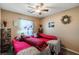 Cozy bedroom with two twin beds, ceiling fan, and large window at 9068 Alluring Ave, Las Vegas, NV 89149