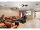 Open living area with leather couches and a view into the kitchen at 9068 Alluring Ave, Las Vegas, NV 89149