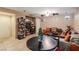 Living room with comfortable seating, a round table, and built-in shelving at 9068 Alluring Ave, Las Vegas, NV 89149
